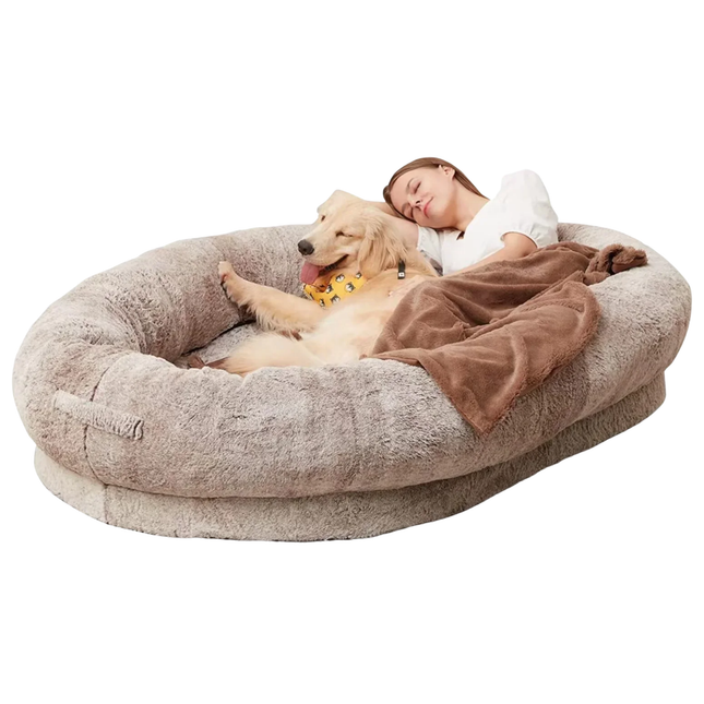 Large donut-shaped pet bed with a dog and person on a white background