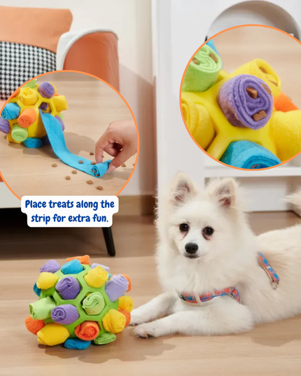 Colorful dog toy with a strip for treats, placed on a wooden floor with a dog nearby.