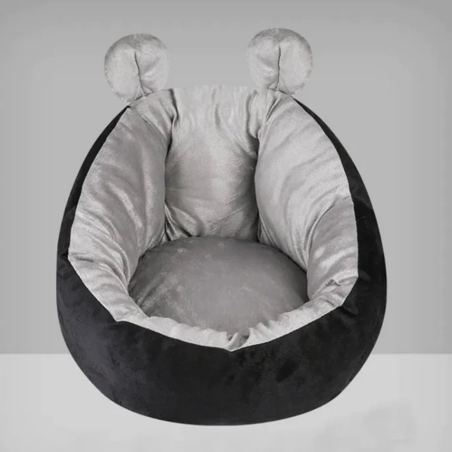 Round pet bed with black exterior and gray interior on a white background