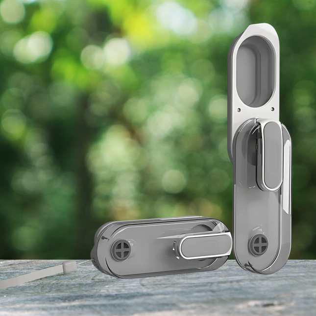 Silver door handle set on a wooden surface with a blurred green outdoor background