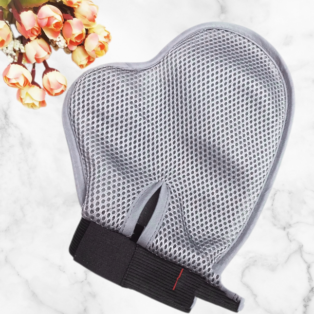 Gray mesh glove with black base on a marble surface with flowers in the corner