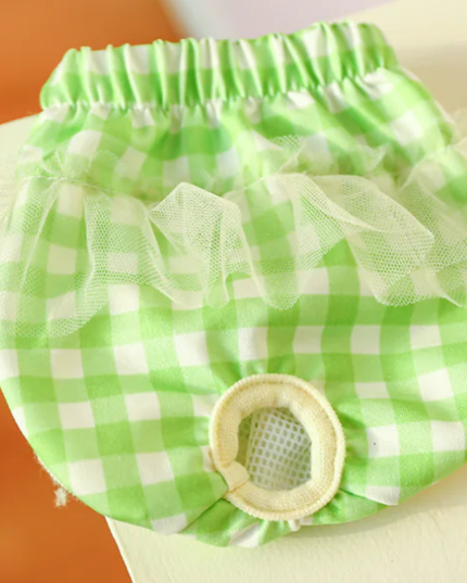 Green checkered diaper cover with ruffles on a white background