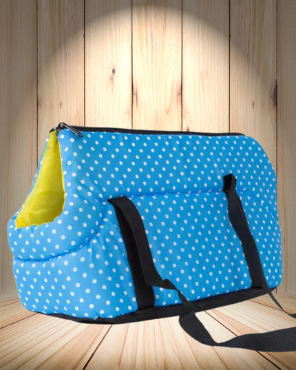 Blue polka dot bag with a yellow item inside on a wooden floor.