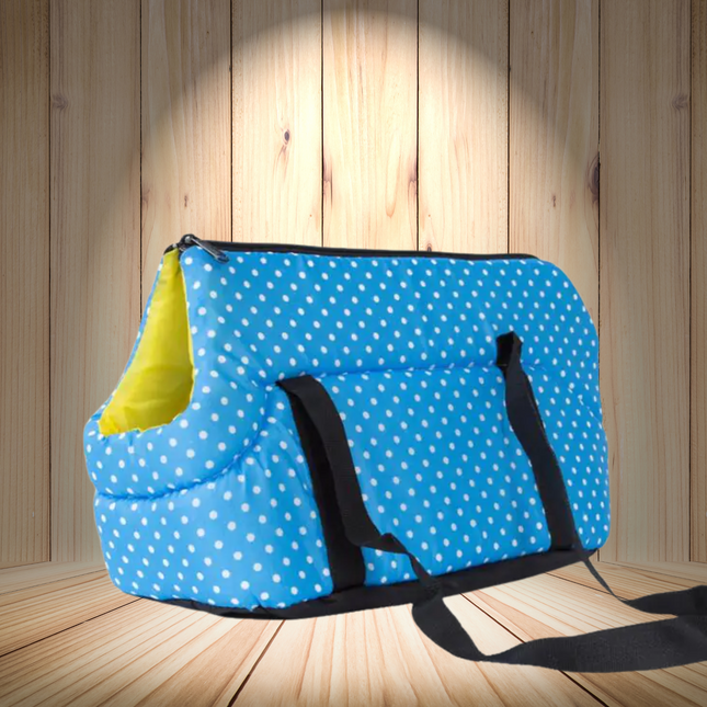Blue polka dot bag with a yellow item inside on a wooden floor.