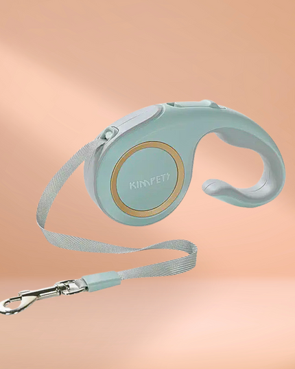 Mint green retractable dog leash with handle on a peach background