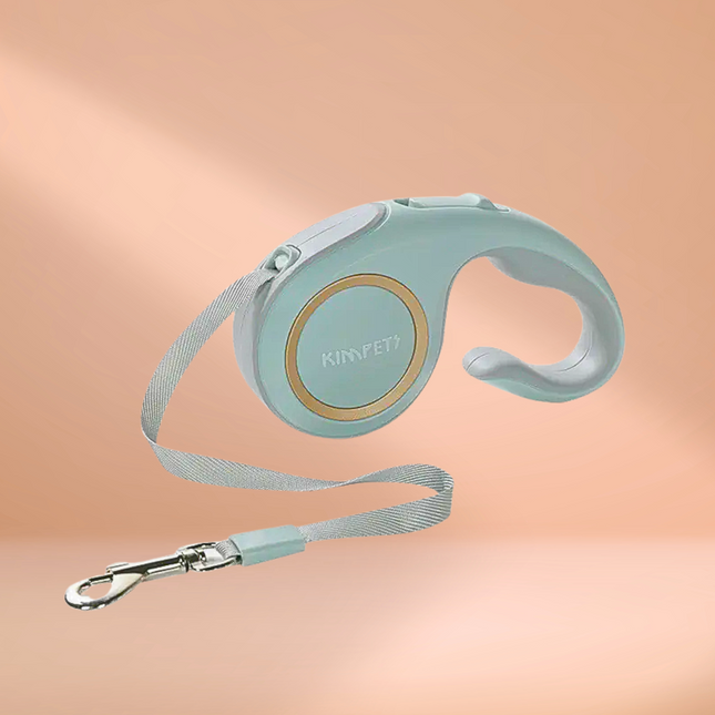 Mint green retractable dog leash with handle on a peach background