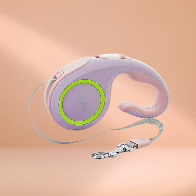 Retractable dog leash with purple handle and green accent on a peach background