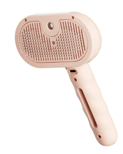 Pink pet grooming brush on a white background