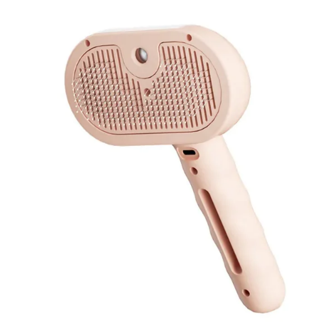 Pink pet grooming brush on a white background