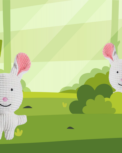 Two white stuffed animals with pink ears in a stylized forest setting