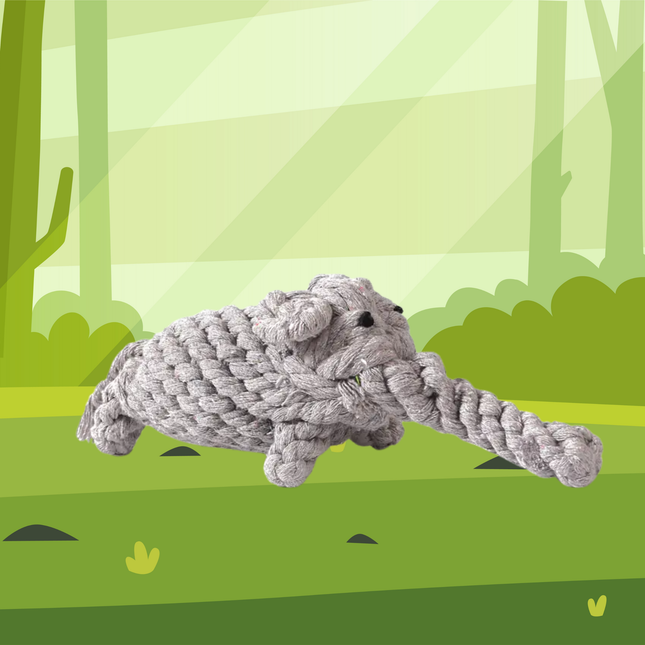 Gray rope toy shaped like a dog on a green forest background