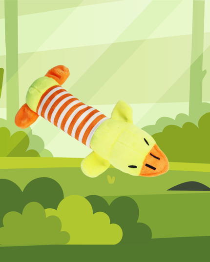 Plush toy duck with striped body in a forest setting