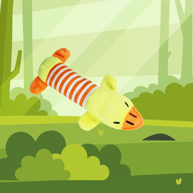 Plush toy duck with striped body in a forest setting