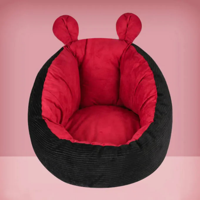Black bean bag chair with red interior on a pink background