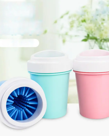 Three colorful silicone cups with lids on a white surface.
