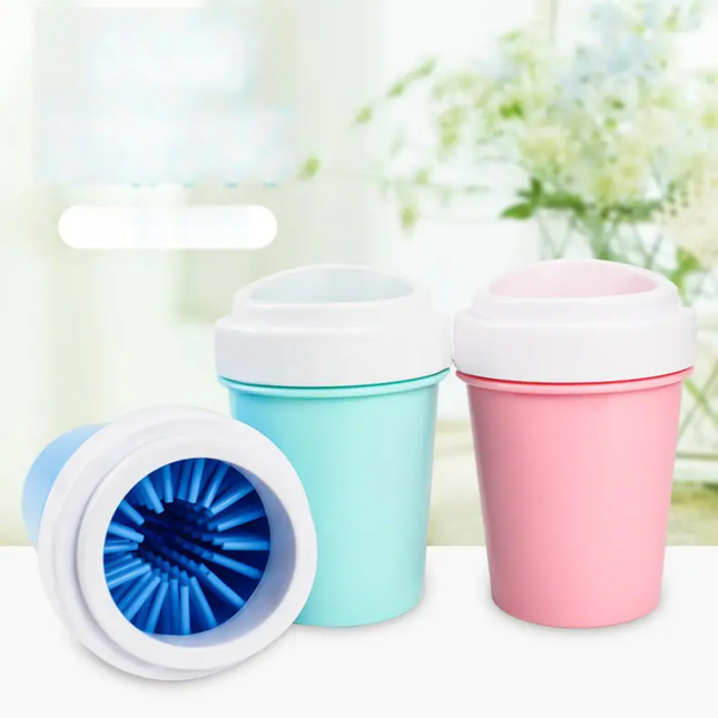 Three colorful silicone cups with lids on a white surface.