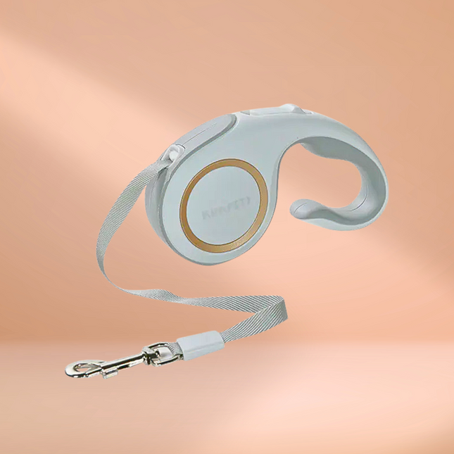 Retractable dog leash with a light blue handle on a peach background