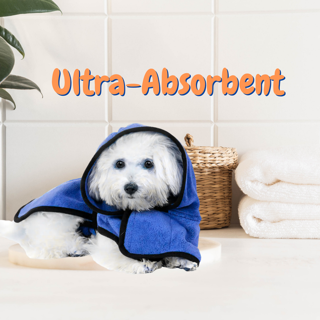 Dog wearing a blue towel with 'Ultra-Absorbent' text in a bathroom setting