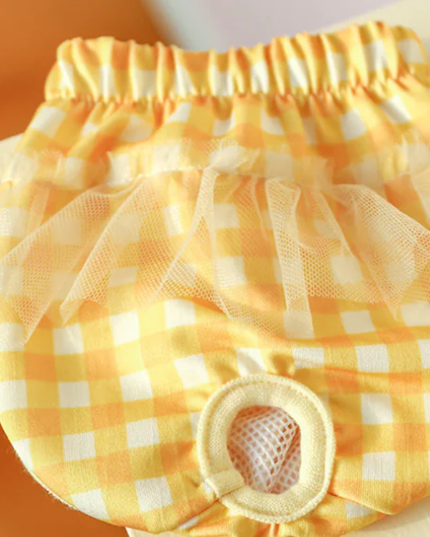 Yellow checkered diaper cover with tulle on a plain background