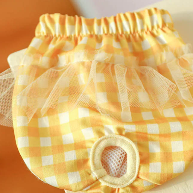 Yellow checkered diaper cover with tulle on a plain background